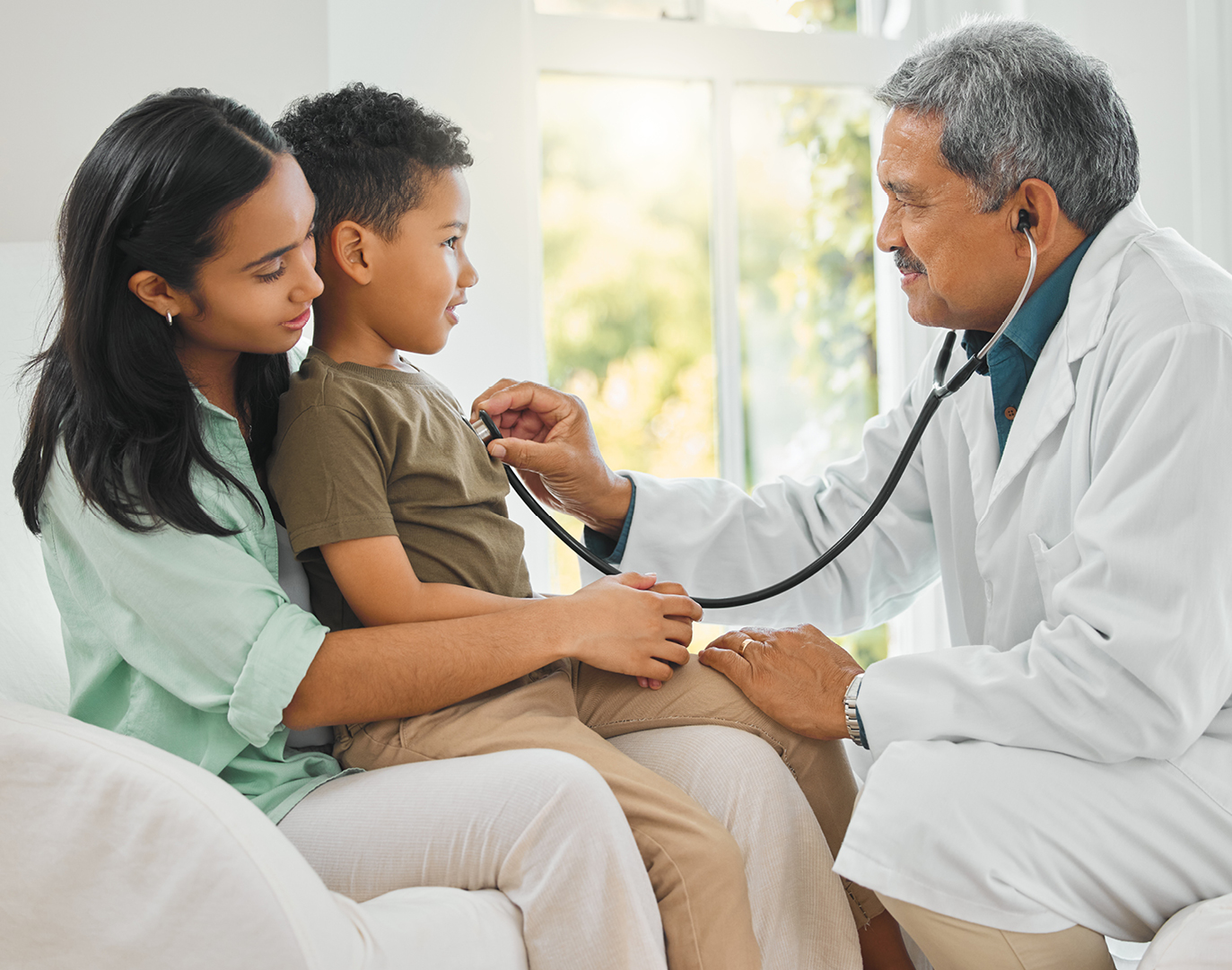 Clinician checking child with stethoscope