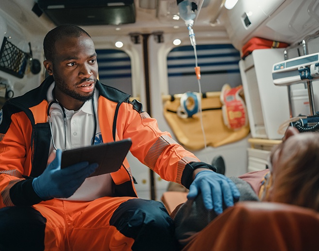 Paramedic providing care inside ambulance