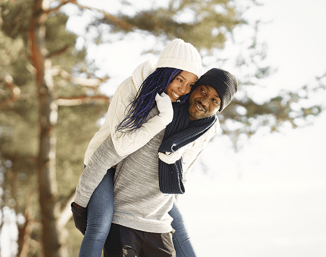 Couple enjoying piggyback ride outdoors