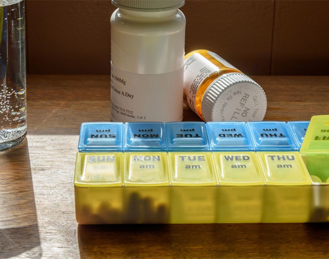 Weekly pill organizer with medication bottles