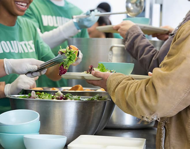 Volunteers serving food to community members