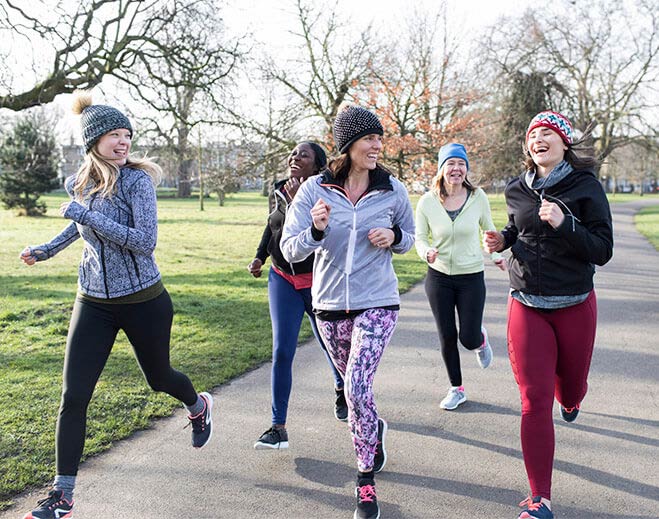 Group jogging together in park outdoors