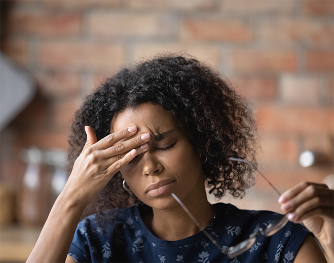 Person holding head with headache
