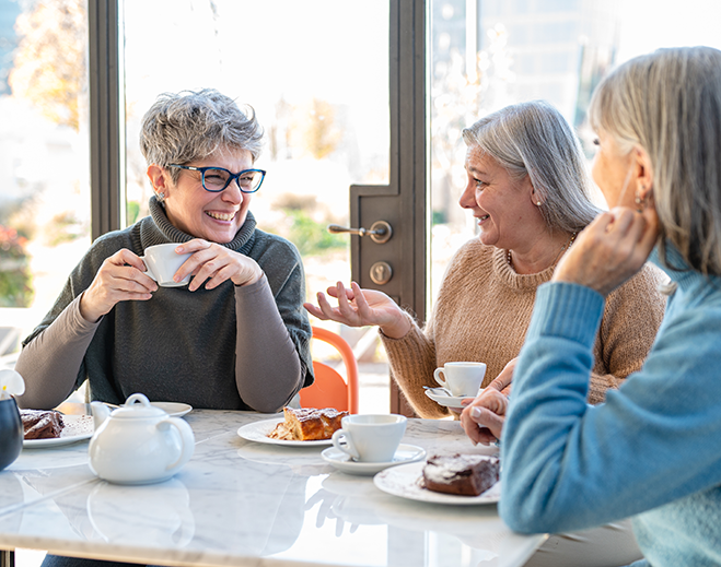 Older adults chatting over coffee and dessert