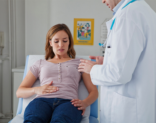 Clinician examining patient in medical room