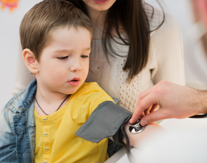 Child receiving blood pressure check