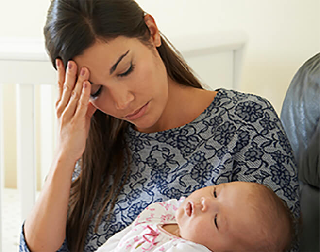 Parent holding baby while feeling unwell