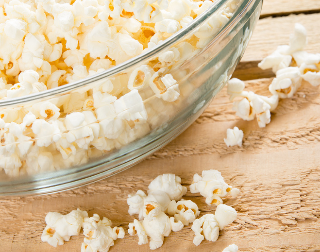 Glass bowl filled with popped popcorn