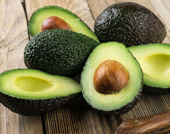 Avocados cut in halves on table