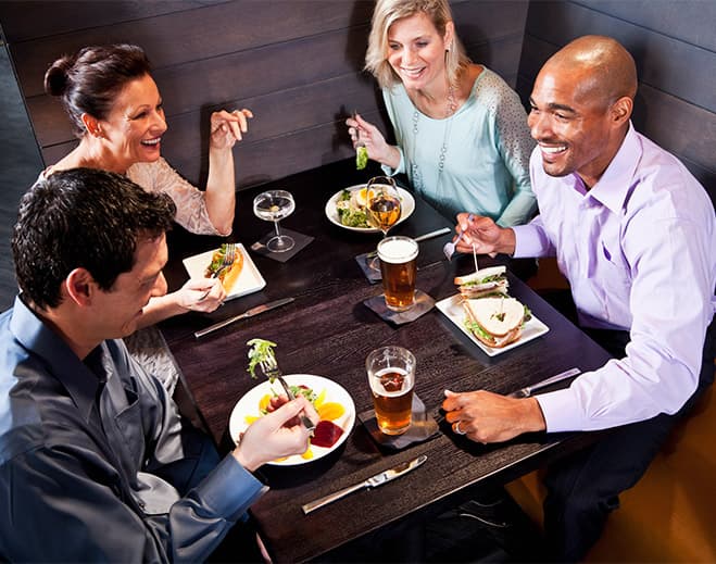 Group enjoying meal at restaurant table
