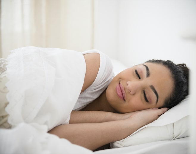 Person sleeping peacefully in bed