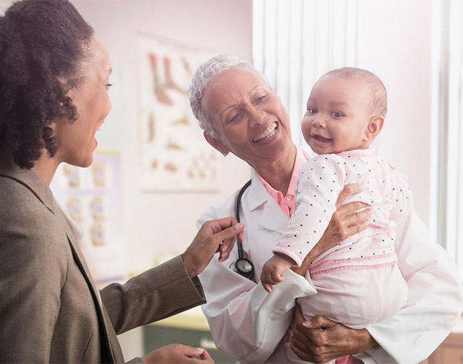 Healthcare provider holding baby during appointment