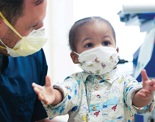 Child wearing mask during medical visit
