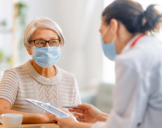 Patient consulting clinician with clipboard
