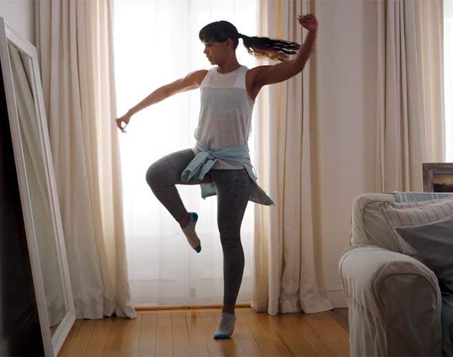 Person dancing indoors near window