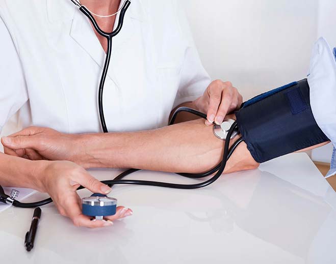Clinician measuring blood pressure with cuff