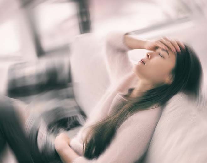 Person lying down with dizziness