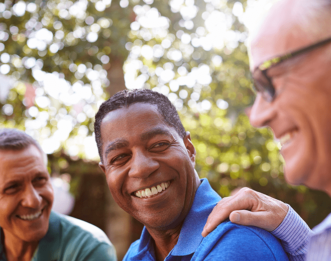 Group of adults smiling outdoors together