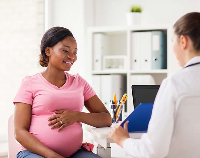 Pregnant patient speaking with clinician
