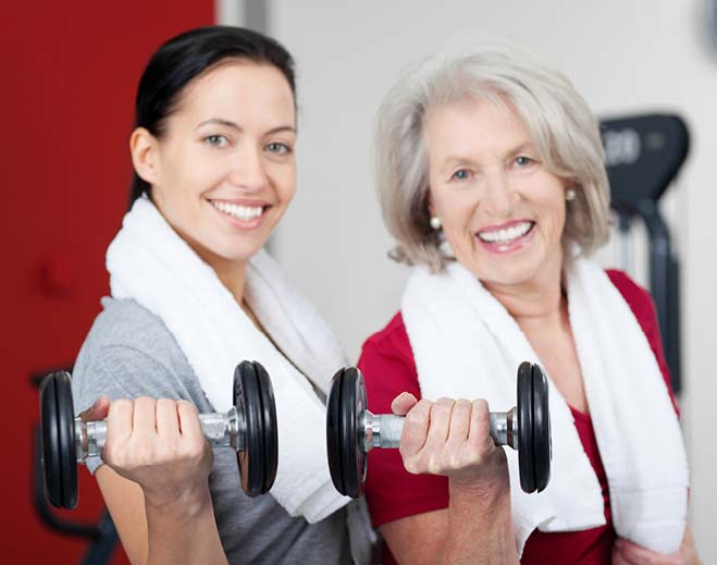 Two people lifting dumbbells together