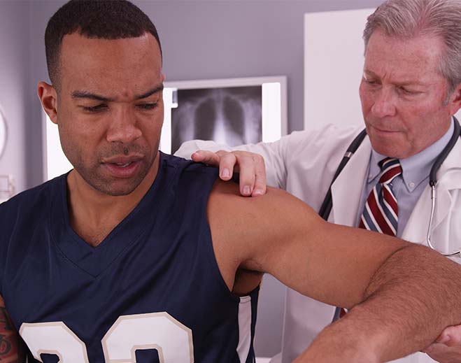 Doctor examining patient shoulder injury