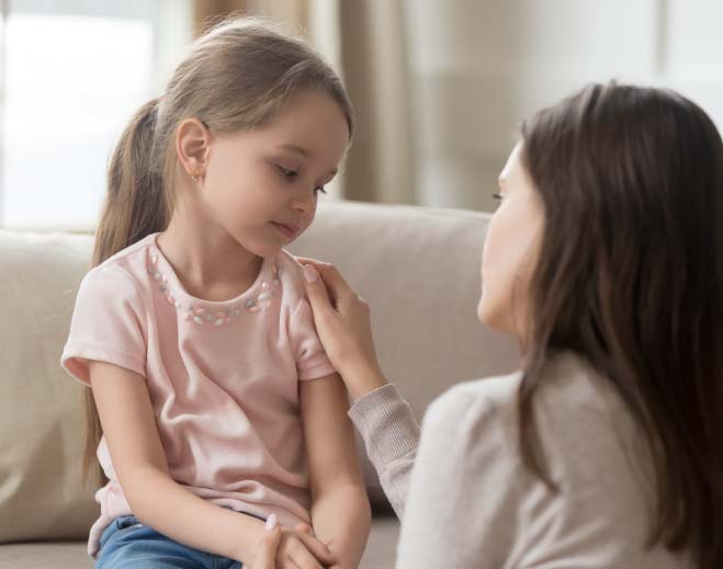 Adult comforting child during conversation