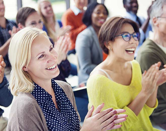 Audience clapping during indoor event