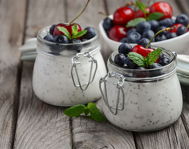 Chia pudding with berries in glass jars