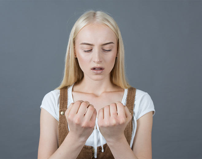 Person looking at hands in concern
