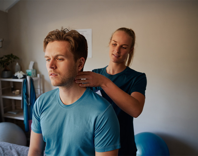 Clinician performing neck therapy on patient