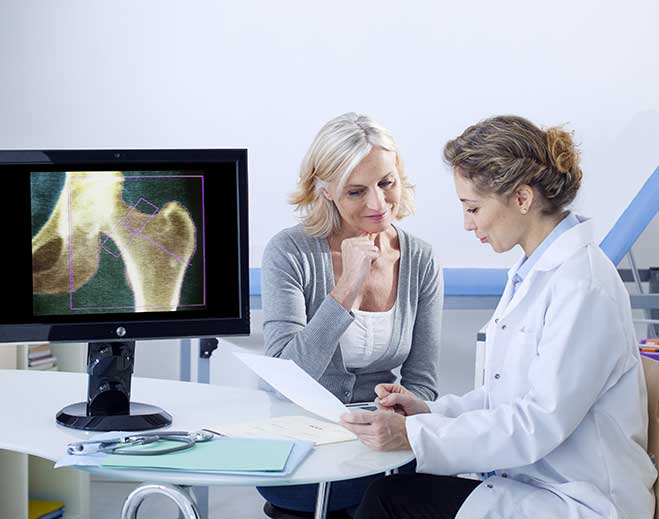 Clinician reviewing hip scan with patient
