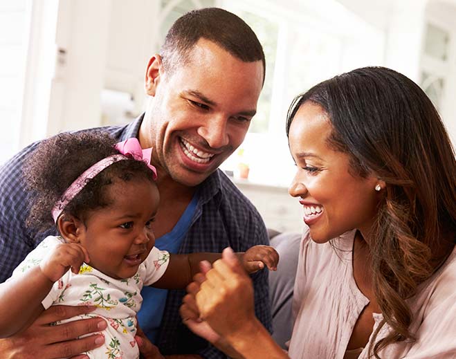 Family playing with baby at home