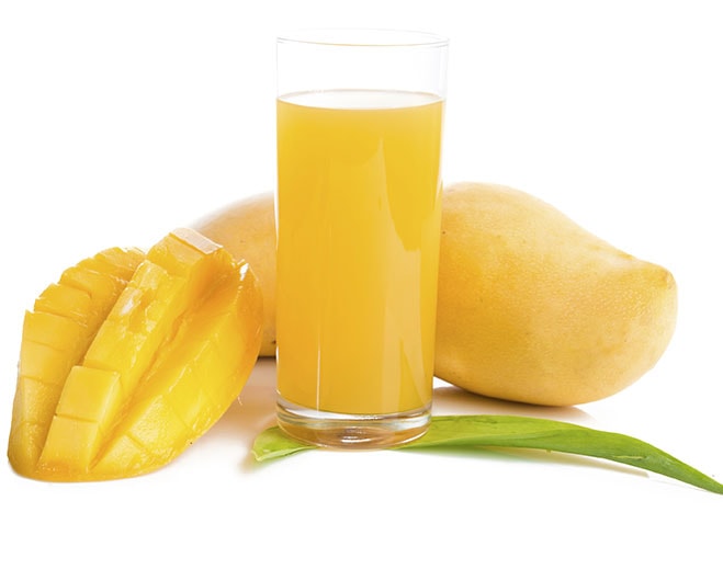 Glass of mango juice with fresh fruit