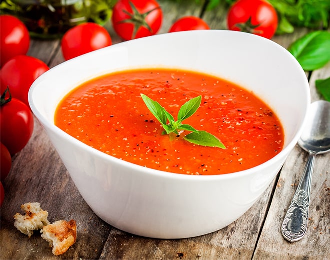 Bowl of tomato soup with fresh basil