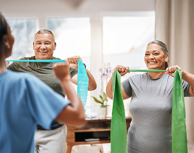 Older adults exercising with resistance bands at home
