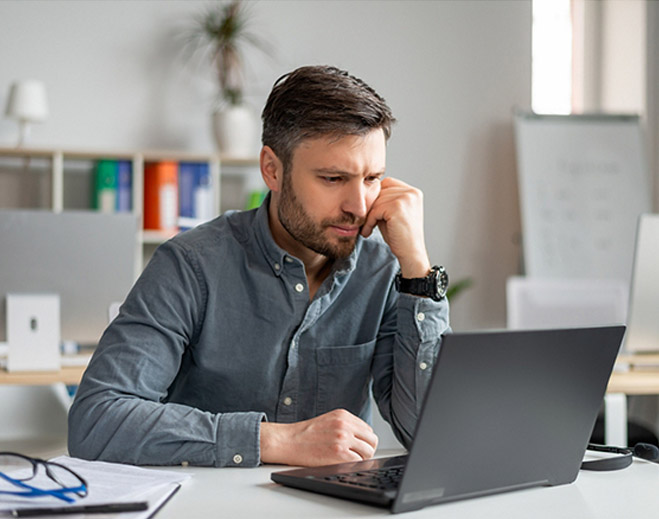 Person working on laptop at desk