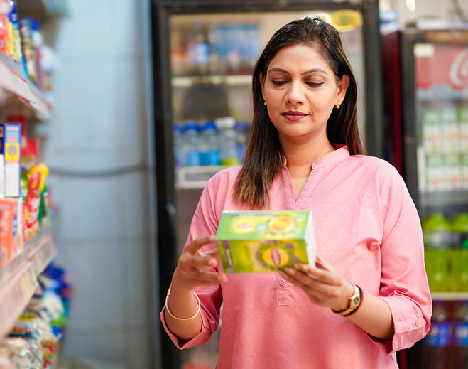 Person reading nutrition label in store