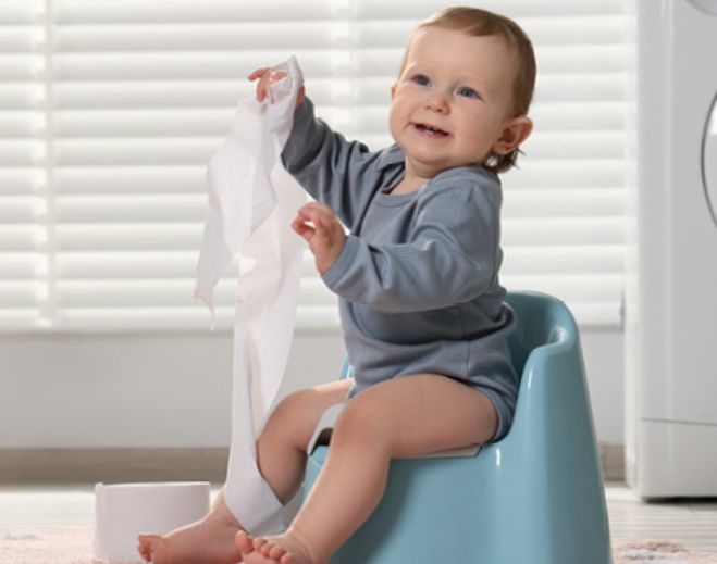 Infant sitting on potty chair