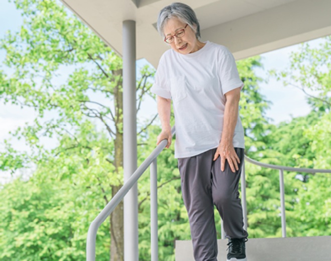 Older adult descending stairs carefully