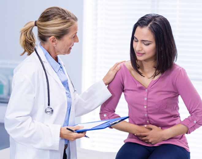 Clinician consulting patient about abdominal pain