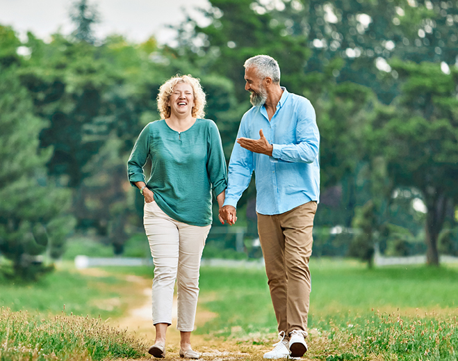 Two people walking together in park
