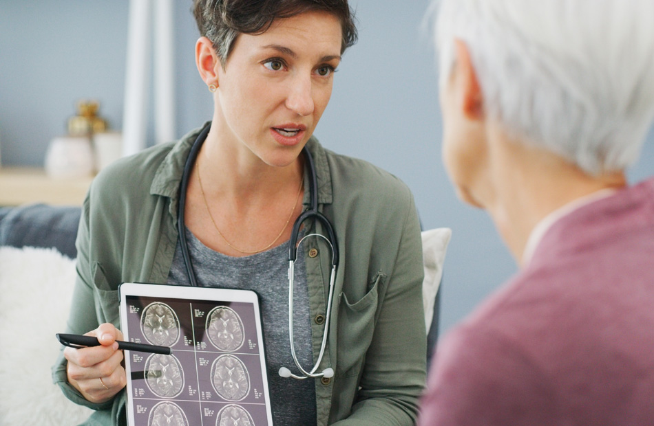 Clinician displaying brain scan images to patien
