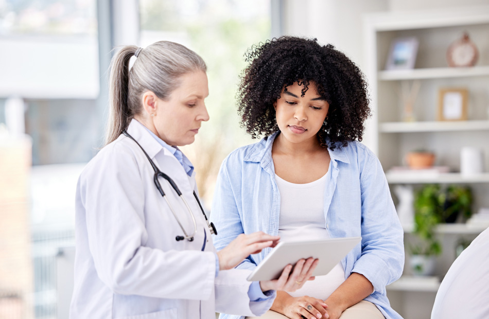 Doctor reviewing information with patient on tablet