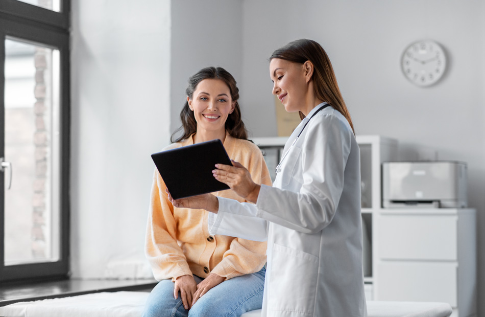 Clinician reviewing information on tablet with patient