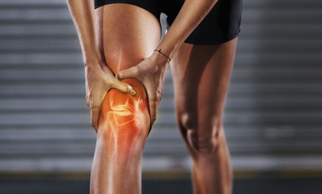 Person holding knee with joint pain
