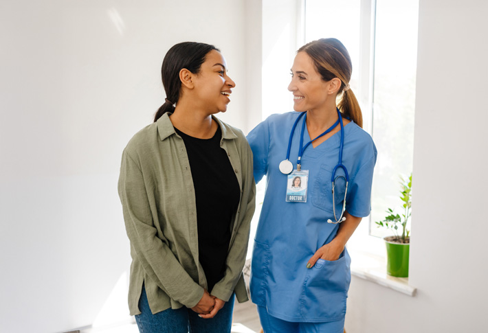 Medical professional supporting patient in clinic