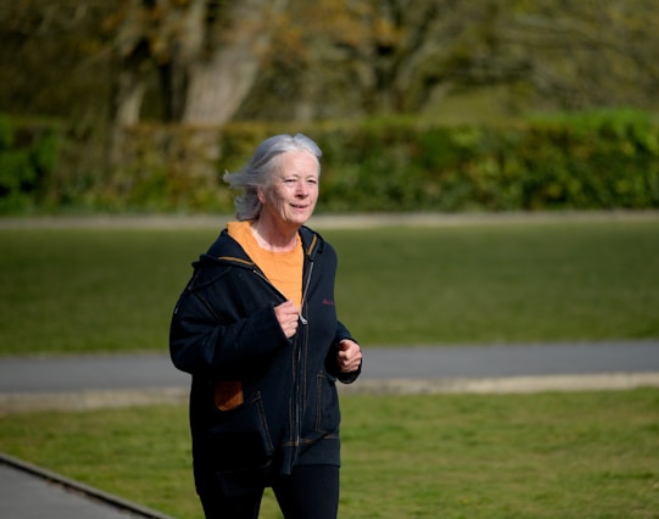 Active senior jogging outdoors in a park