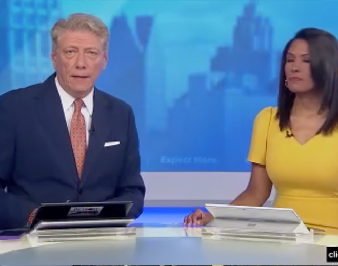 Television news anchors at studio desk
