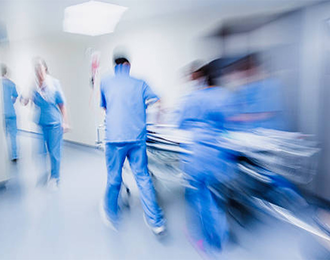Hospital staff rushing through hallway