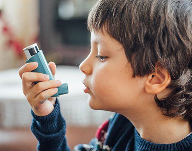 Child using asthma inhaler